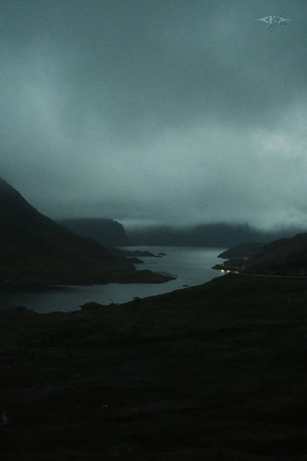 Storm clouds over a fjord under the midnight sun